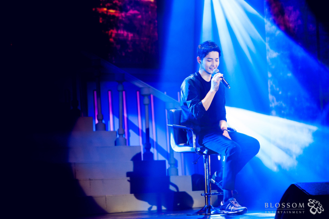 Song Joong-ki speaks at the fan meeting in Beijing on Saturday. (Blossom Entertainment)