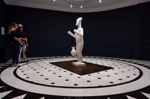 Visitors look at the marble statue “Standing Figure” by Chinese artist and activist Ai Weiwei, created especially for the Cycladic Museum, during his exhibition entitled “Ai Weiwei at Cycladic” at Athens Cycladic Museum in Athens on May 20. (AFP-Yonhap)