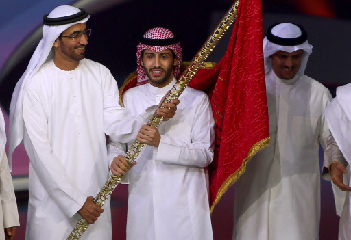 Kuwait’s Rajih al-Hamidani (center) receives the “flag of poetry” after winning the final of the televised program “Million’s Poet” on May 17, at Abu Dhabi’s Al-Raha Theatre. (AFP-Yonhap)