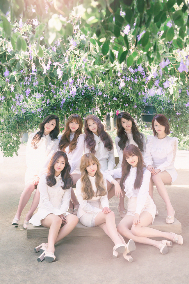 Girl group Lovelyz poses in a garden clad in white costumes. (Woollim Entertainment)