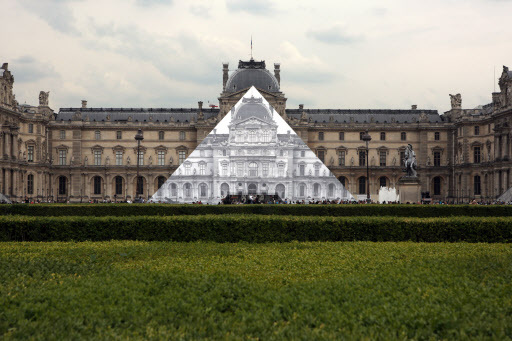 The Louvre Pyramid is covered with a giant black-and-white photo of the 16th-century buildings surrounding the monument by French street artist JR in Paris, France, on Saturday. (UPI-Yonhap)