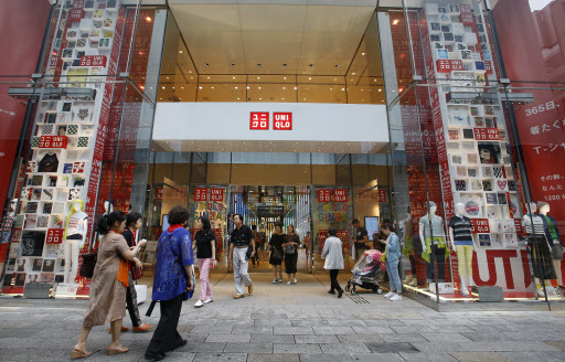 Shoppers enter Uniqlo’s flagship store in Tokyo’s Ginza shopping district on June 9. (AP-Yonhap)