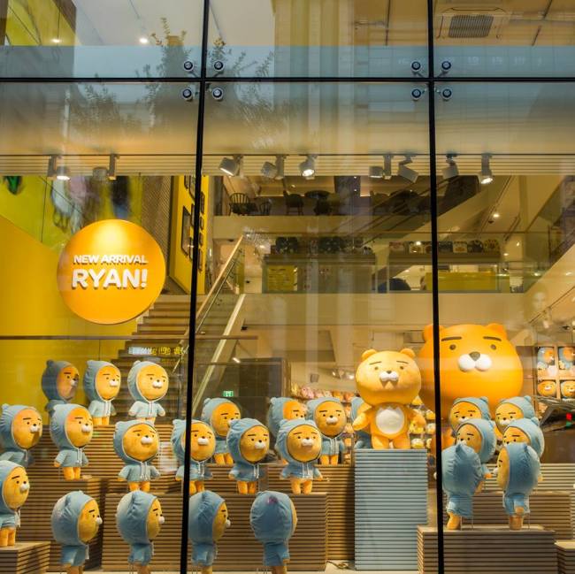 The Kakao Friends Flagship Store in Gangnam Seoul on opening day in July 2016 with a long line of visitors waiting to enter the three story Ryan themed retail building