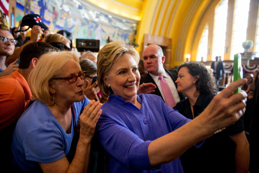Democratic presidential candidate Hillary Clinton takes a photo with a member of the audience following a rally at the Cincinnati Museum Center at Union Terminal in Cincinnati on June 27. (AP-Yonhap)
