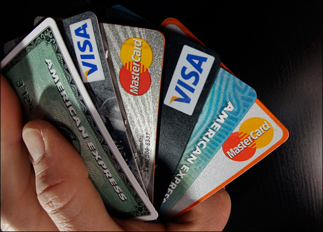A stack of credit cards including Visa/ The Investor