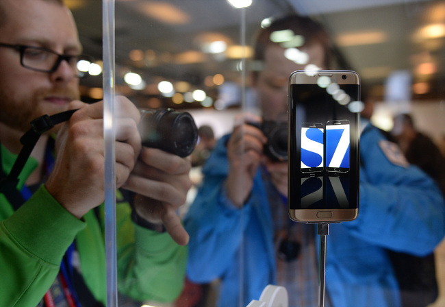 Journalists take photos of Samsung's Galaxy S7 phone at the launch event held in Barcelona in February.