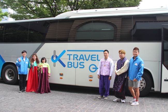 Travelers dress in hanbok and pose in front of the K-Travel bus in Daegu on June 29. (Julie Jackson/The Korea Herald)