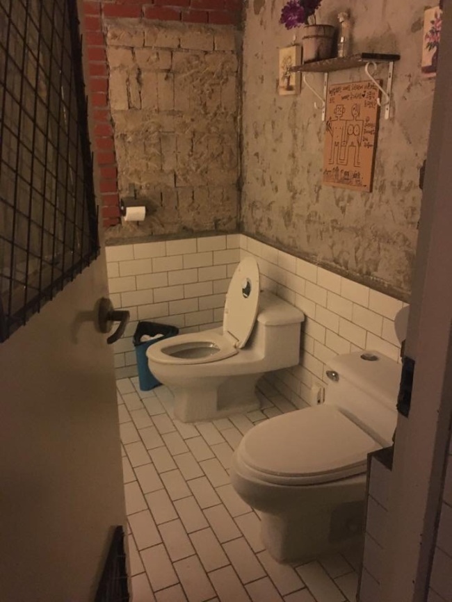 Inside a public women's bathroom in a bar in Seoul's Sinchon area, with a vulgar poster put up on the wall. (Credit: Min Soo-ji)