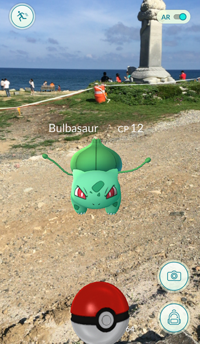CATCHING POKEMON IN ULSAN — Pokemon character Bulbasaur appears on the smartphone screen of a local citizen playing "Pokemon Go" near Ganjeolgot, a coastal park in the southeastern city of Ulsan in South Korea on Friday. (Yonhap)