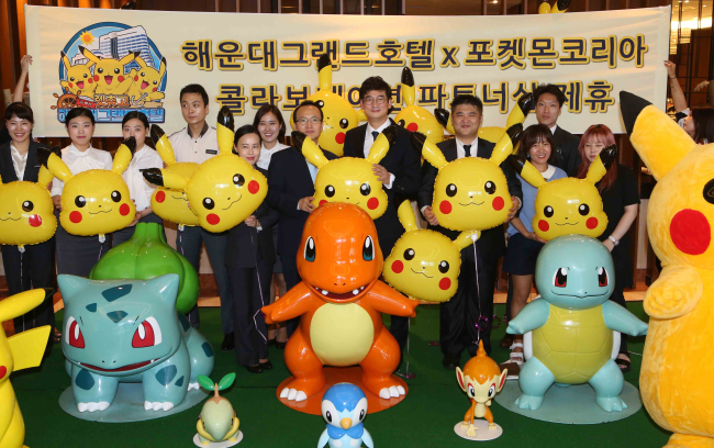 The Haeundae Grand Hotel in Busan and Pokémon Korea celebrate their partnership during a ceremony held at the hotel on July 21. The hotel is offering diverse Pokémon-themed rooms, merchandise and eateries this summer as part of its joint promotion with Pokémon Korea. (Yonhap)