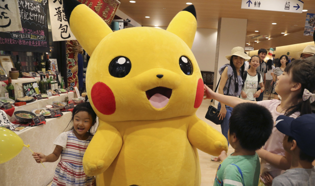 Pikachu is surrounded by children during a Pokemon festival in Tokyo on July 18 (AP-Yonhap)