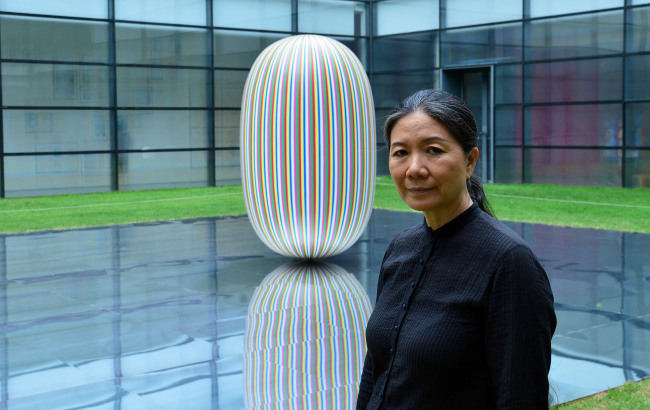 Artist Kim Soo-ja poses with the sculpture “Deductive Object” in the National Museum of Modern and Contemporary Art’s courtyard. (Yoon Byung-chan/The Korea Herald)