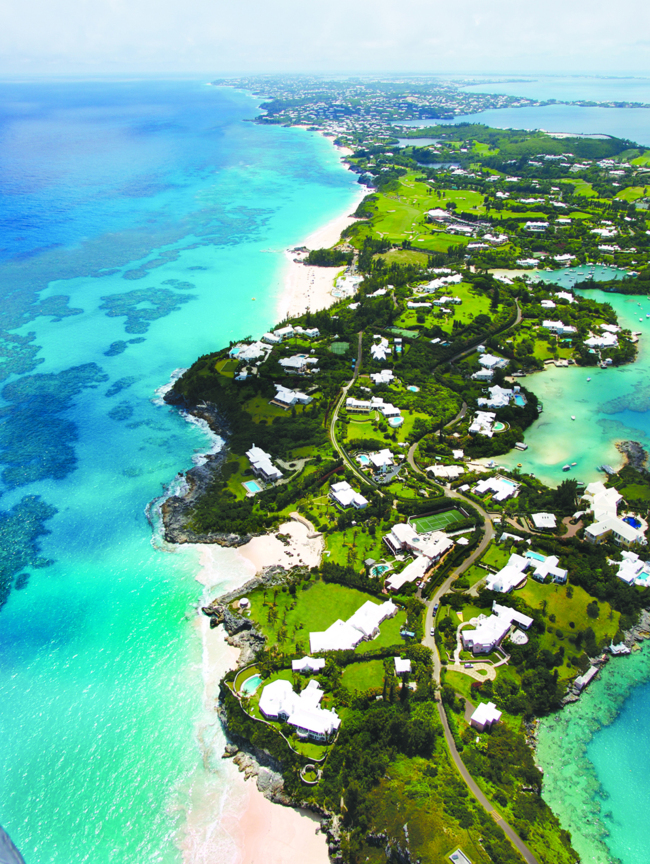 An aerial view of Bermuda, where luminous turquoise waters lap shell-pink sand beaches, frangipani perfumes the air, and pastel colored houses snuggle behind winding hedgerow-bordered roads. (Bermuda Tourism Authority/TNS)