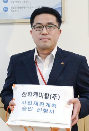 김학수 한화케미칼 사장이 16일 오후 정부세종청사 산업통상자원부부 기업활력법 사업재편 신청 창구에서 국내 기업 가운데 처음으로 원샷법 승인 신청 접수를 하고 있다. ［사진=헤럴드경제DB］