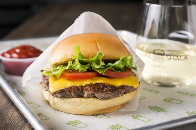 A Shack Burger accompanied by wine.