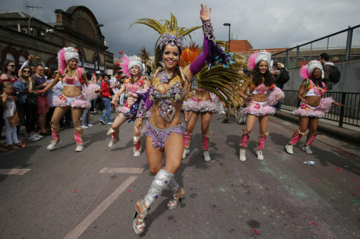 A performer in costume poses on the second day of the Notting Hill Carnival in west London on Monday. (AFP-Yonhap)