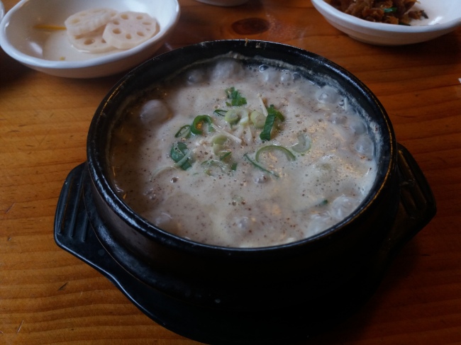 Giwajib Sundubu's mushroom deullkkae-tang speckled with ground perilla seed powder (Christine Cho)