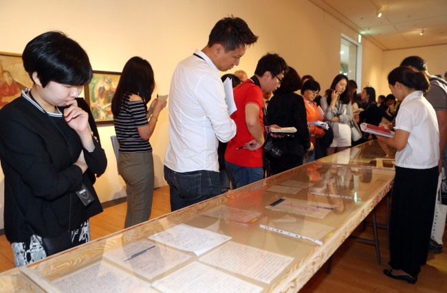 Visitors view the Busan Biennale exhibition during the press opening on Friday in Busan. (Yonhap)