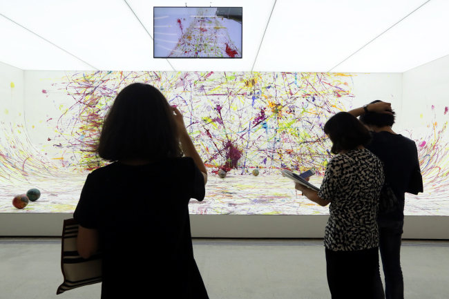 Visitors view “Soccer Painting by the Soccer Ball Bouncing Over Crocodile River” by Ham Kyung-ah. (Yonhap)