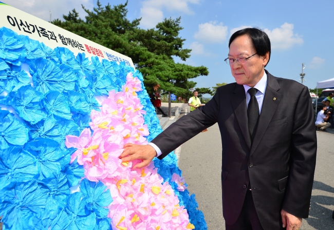 NH농협금융지주 김용환 회장이  한반도 모양 지도에 통일염원 무궁화 꽃을 부착하고 있다.
사진=NH농협금융 제공