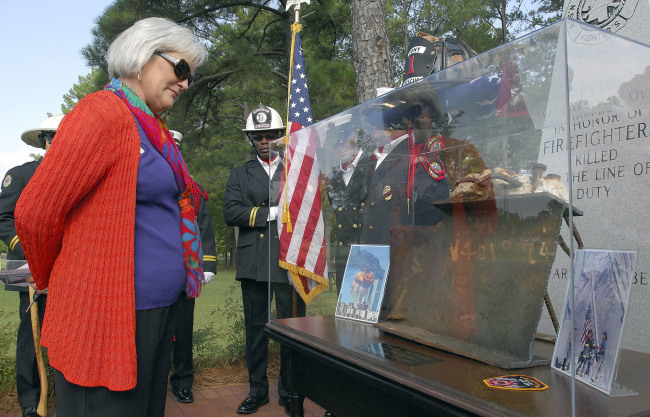 Cookie Bell, the wife of Mississippi State Fire Academy Executive Director Reggie Bell, looks at a display made with a salvaged section of the World Trade Center after its unveiling during a 9/11 memorial ceremony in Pearl, Mississippi. (AP - Yonhap)