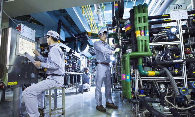SK Biotek employees at work inside the company’s production facility in Daejeon. SK Biotek