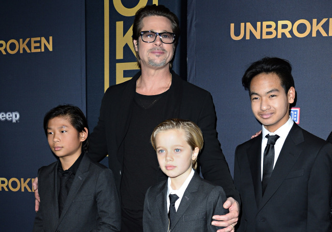 Brad Pitt and children Pax Jolie-Pitt (left), Shiloh Jolie-Pitt (center) and Maddox Jolie-Pitt as they arrive for the US premiere of Universal Pictures “Unbroken,” at the Dolby Theatre in Hollywood, California, on Dec. 15, 2014. (Yonhap-AFP)