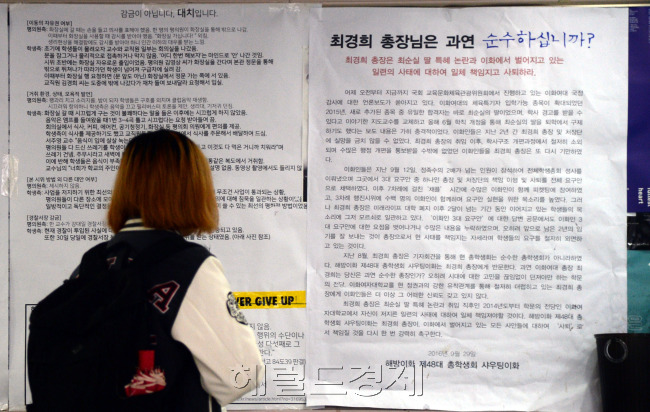 [사진=이대 학내에서 최경희 총장의 사퇴를 촉구하는 대자보를 한 학생이 유심히 들여다보고 있다. 박현구 기자/phko@heraldcorp.com]
