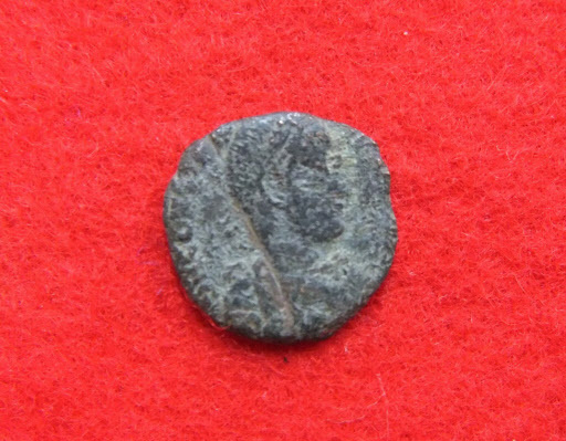This Sept. 21 photo released by the Uruma City Board of Education shows the head of a coin, which likely dates to the Roman Empire, found with nine other coins during an excavation at Katsuren Castle in Uruma on Japan’s southernmost prefectural island of Okinawa. (AP-Yonhap)