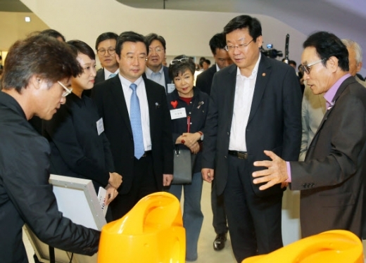 Joo Hyung-hwan (second from right), Korea’s Minister of Trade, Industry and Energy, looks at prototypes of design products at a design-related event held at Dongdaemun Design Plaza in August. (Yonhap)