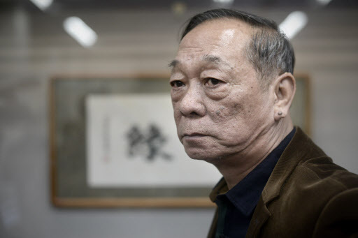 Jin Yulan, the nephew of China’s last emperor Pu Yi, looks on during his private antique collection show in Beijing on Monday. (AFP-Yonhap)