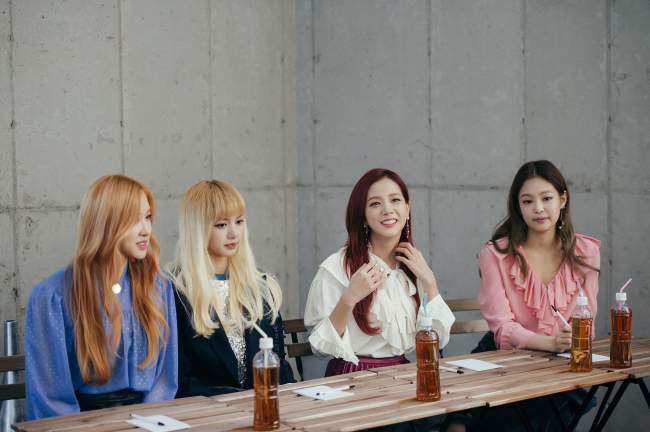 From left: Black Pink’s Rose, Lisa, Jisoo and Jennie speak to the press Wednesday in northern Seoul. (YG Entertainment)