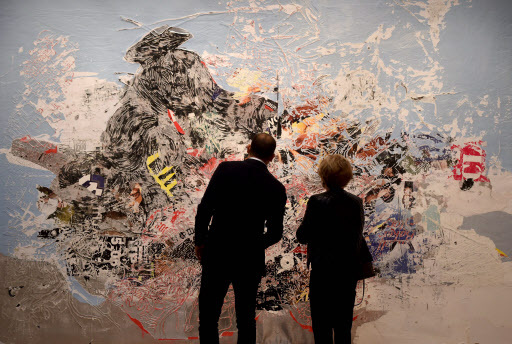 People look at Mark Bradford's “Let’s Make Christmas Mean Something This Year” on display during the media preview on Friday for Sotheby’s New York evening auctions of impressionist, modern and contemporary art in New York. (AFP-Yonhap)