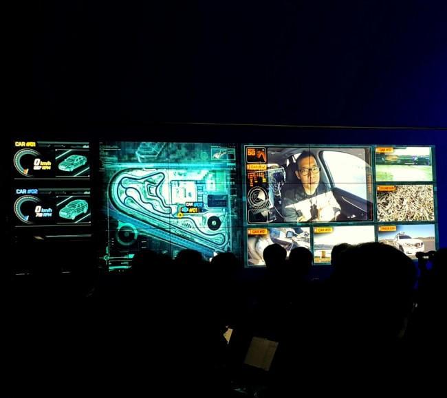 A multi-screen display shows rapper-turned-racer Kim Jin-pyo test driving the T5 in a demonstration held at the BMW Driving Center in Incheon, Tuesday (Sohn Ji-young/The Korea Herald)
