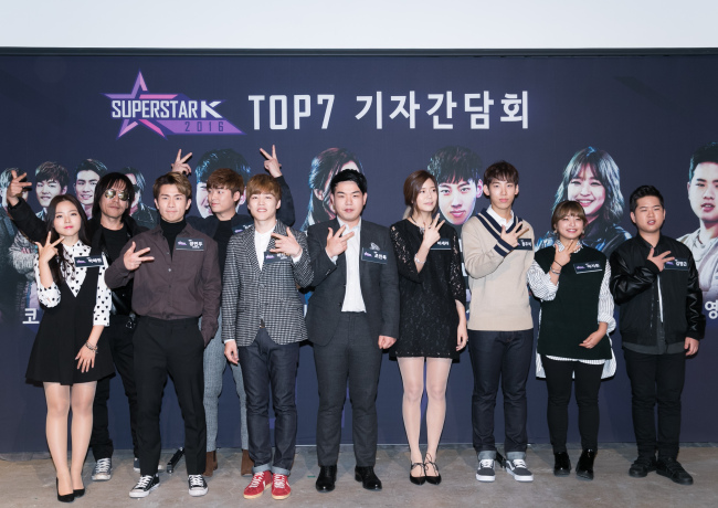 The top seven finalists of singing audition program “Superstar K” pose for a photo at a press conference in southern Seoul on Tuesday. (CJ E&M)