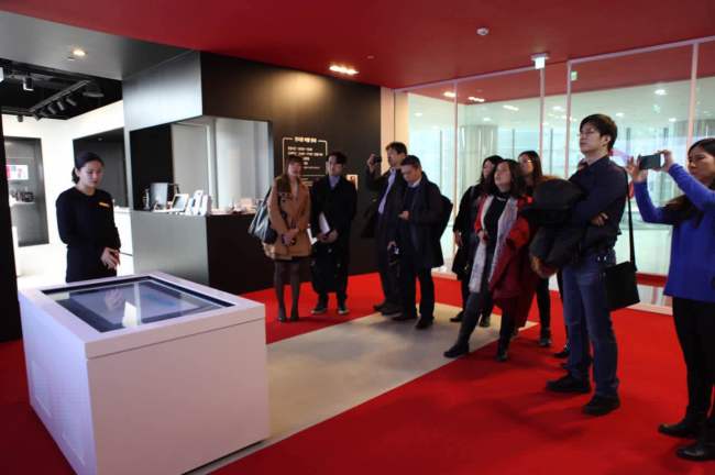 Reporters from Korea, China and Japan tour an exhibition center at the Gyeonggi Center for Creative Economy and Innovation on Nov. 16. (Park Ga-young/The Korea Herald)
