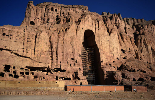 This picture taken on Nov. 6 shows Afghan men walk at the site of the giant Buddha statues, which were destroyed by the Taliban in 2001 in Bamiyan province. (AFP-Yonhap)