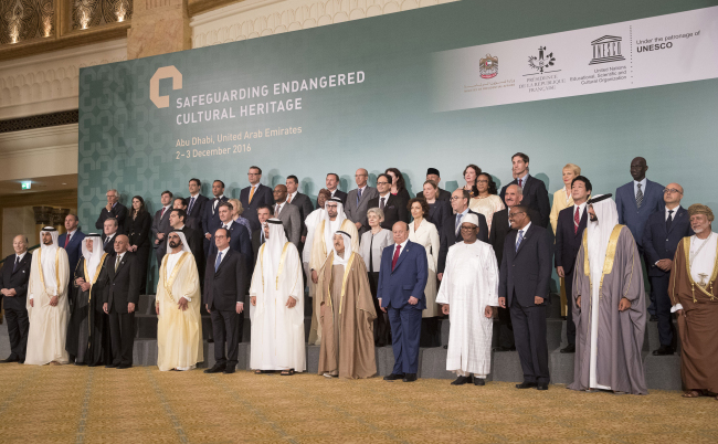 On Saturday, French President Francois Hollande (bottom left), poses for a photo between Sheikh Mohammed bin Zayed al-Nahyan, crown prince of Abu Dhabi and UAE’s deputy commander-in-chief of the armed forces, on his right, and Sheikh Mohammed bin Rashid al-Maktoum, UAE prime minister and ruler of Dubai, with the other head of states and dignitaries during the Safeguarding Endangered Cultural Heritage Conference at Emirates Palace in Abu Dhabi, United Arab Emirates. (AP-Yonhap)