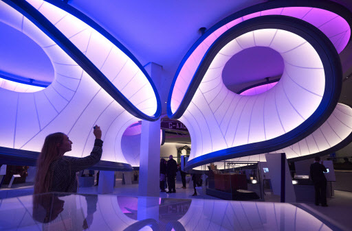 A woman uses a cellphone to photograph a new gallery, Mathematics: The Winton Gallery, inside the Science Museum during a press view in London on Wednesday. (AFP-Yonhap)