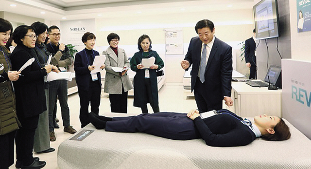 김경수 에몬스가구 회장(맨 오른쪽)이 대리점주들에게 심박수, 호흡수, 뒤척임 등 수면패턴을 실시간으로 분석해 알려주는 ‘스마트침대’에 관해 설명하고 있다.
