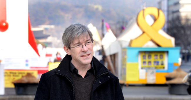 Film critic Darcy Pacquet poses for a photo in Gwanghwamun Square on Tuesday. (Park Hyun-koo/The Korea Herald