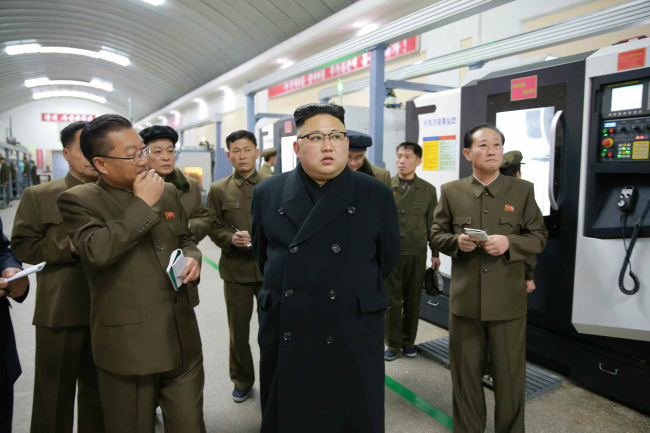 North Korean leader Kim Jong-un visits a precision machine factory in Pyongyang (Yonhap)