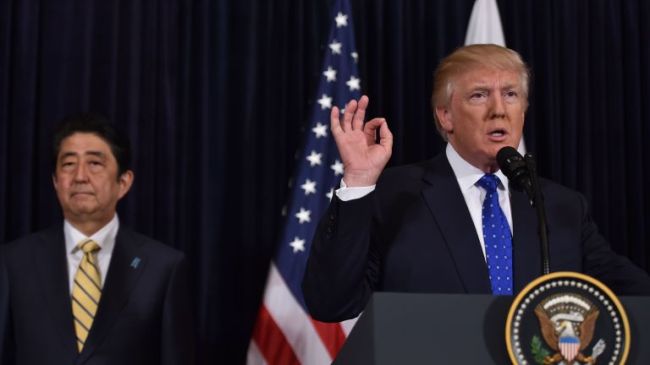 Japanese Prime Minister Shinzo Abe (L) and US President Donald Trump speak at Trump's Mar-a-Lago resort in Palm Beach, Florida, on February 11, 2017, after North Korea reportedly fired a ballistic missile, the first since Donald Trump became US president. (NICHOLAS KAMM/AFP/Getty Images)