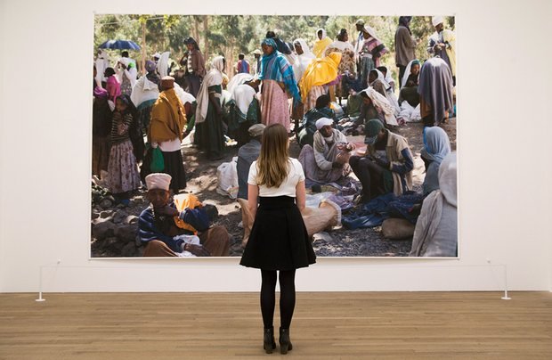 An employee poses in front of an artwork entitled “Market I, 2012” by German photographer Wolfgang Tillmans, during a photocall to promote the forthcoming exhibition “Wolfgang Tillmans: 2017” at the Tate Modern in London on Tuesday. (AFP-Yonhap)