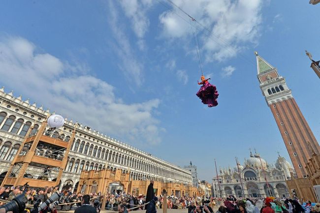 Claudia Marchiori, winner of last year’s Maria of the Carnival contest, descends from the Bell Tower in St. Mark’s Square during the traditional Flight of the Angel event that marks the official opening of the celebrations of St. Mark’s Square at the Venice Carnival in Venice, northern Italy, Sunday.