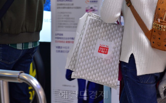 사진은 3일 서울 소공동에 위치한 롯데면세점을 찾은 중국인 관광객이 롯데면세점 쇼핑백을 들고 있다. [사진=이상섭 기자/babtong@heraldcorp.com]
