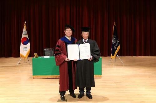 장복만(오른쪽) 회장이 명예법학사 학위를 받은 후 한석정 동아대 총장과 기념사진을 찍고 있다.