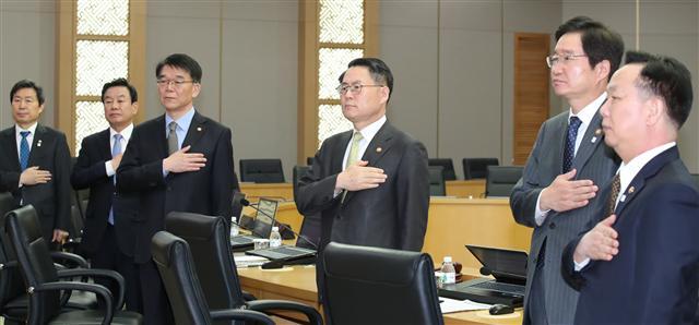 28일 오전 정부세종청사에서 열린 세종-서울 간 영상국무회의에서 국무위원들이 국기에 대한 경례를 하고 있다. 이날 회의에서는 새정부의 몫이 될 내년도 예산에 대한 지침 의결이 있었다. [연합뉴스]