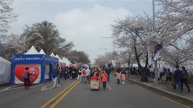 롯데월드타워 불꽃쇼, 공공전시 프로젝트 ‘스위트 스완’ 등으로 홍보효과를 낸  ‘석촌호수 벚꽃축제’에 지난 9일 방문객이 몰린 모습.