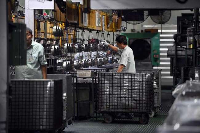 Workers at Panasonic‘s refrigerator compressor factory in Bedok   The Straits Times